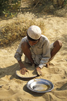 Boy Washing Dishes in Rajasthani Desert near Jaisalmer, India