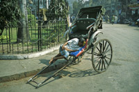 Man Sleeping on Rickshaw in Calcutta, India